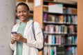 Happy African girl student using mobile phone. Portrait. Copy space Royalty Free Stock Photo