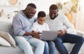 Happy African Granddad, Father And Preteen Son Using Laptop At Home Together Royalty Free Stock Photo