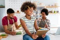 Happy african american preeteen girl using digital tablet for education, fun at home. Family concept