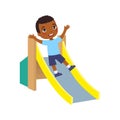 Happy African little  boy slides off a children`s slide. Joyful dark skin child, summer vacation Royalty Free Stock Photo