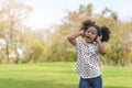 Happy african little girl have big smile, her listening music with headphones and  dancing at outdoors park Royalty Free Stock Photo