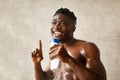 Happy African Male Singing Holding Shower Gel Bottle In Bathroom Royalty Free Stock Photo