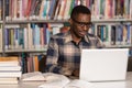 Happy African Male Student With Laptop In Library Royalty Free Stock Photo