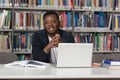 Happy African Male Student With Laptop In Library Royalty Free Stock Photo