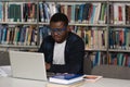 Happy African Male Student With Laptop In Library Royalty Free Stock Photo