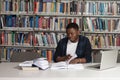 Happy African Male Student With Laptop In Library Royalty Free Stock Photo