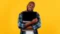 Happy African Man Hugging Laptop Computer Standing Over Yellow Background Royalty Free Stock Photo