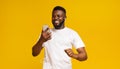 Happy african man listening music with earphones and mobile phone Royalty Free Stock Photo