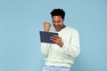 Happy african man looking at tablet Royalty Free Stock Photo