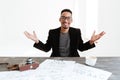 Happy African man in suit sitting by the table Royalty Free Stock Photo