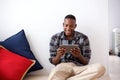 Happy african man using digital tablet at home Royalty Free Stock Photo