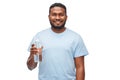 Happy african man with water in glass bottle Royalty Free Stock Photo