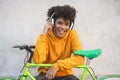 Happy african millennial guy listening music playlist outdoor - Young man having fun with technology trends - Tech, generation z Royalty Free Stock Photo