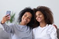 Happy african mom with teen daughter take selfie on smartphone Royalty Free Stock Photo