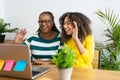 Happy African mother and daughter greeting the family in online video call with laptop