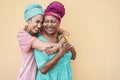 Happy african mother and daughter hugging each others - Focus on senior woman