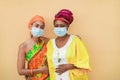 Happy african mother and daughter wearing safety masks - Focus on faces Royalty Free Stock Photo