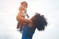 Happy african mother playing with her daughter outdoor - Afro mum and child having fun together - Family, happiness and love