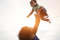 Happy african mother playing with her daughter outdoor - Afro mum and child having fun together - Family, happiness, real people