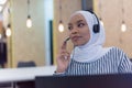 Happy african muslim woman in call center. Female Customer Service Representative Answer Client`s Questions in a Headset. Multi- Royalty Free Stock Photo