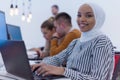 Happy african muslim woman in call center. Female Customer Service Representative Answer Client`s Questions in a Headset. Multi- Royalty Free Stock Photo