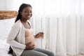 Happy African Pregnant Woman Drinking Water From Glass While Relaxing On Bed Royalty Free Stock Photo