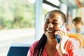 Happy African senior woman having a call with smartphone while traveling with bus Royalty Free Stock Photo