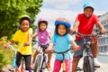 Happy African siblings riding bikes in summer city Royalty Free Stock Photo