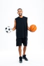 Happy african sports man holding basketball and soccer ball Royalty Free Stock Photo