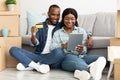 Happy African Spouses With Digital Tablet And Credit Card Choosing Furniture Online Royalty Free Stock Photo