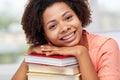 Happy african student girl with books at home