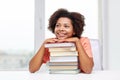 Happy african student girl with books at home