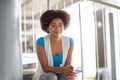 Happy african student girl sitting on stairs Royalty Free Stock Photo