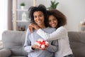 Happy african teen daughter congratulating mom hugging looking at camera Royalty Free Stock Photo