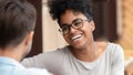 Happy african woman and caucasian boyfriend laugh on first date Royalty Free Stock Photo