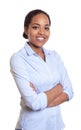 Happy african woman with crossed arms in a blue shirt Royalty Free Stock Photo