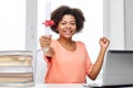 Happy african woman with laptop, books and diploma Royalty Free Stock Photo