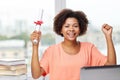 Happy african woman with laptop, books and diploma Royalty Free Stock Photo