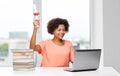Happy african woman with laptop, books and diploma Royalty Free Stock Photo