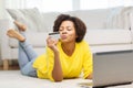 Happy african woman with laptop and credit card Royalty Free Stock Photo