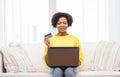 Happy african woman with laptop and credit card Royalty Free Stock Photo