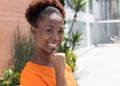 Happy african woman in a orange shirt Royalty Free Stock Photo