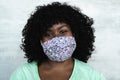 Happy African woman portrait - Afro girl wearing protective face mask for preventing spread of corona virus Royalty Free Stock Photo