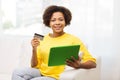 Happy african woman with tablet pc and credit card Royalty Free Stock Photo