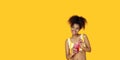 Happy african woman wear yellow clothes holding drink look aside at copy space