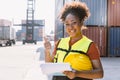 Happy African women worker in port cargo shipping industry standing smile Royalty Free Stock Photo