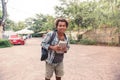 Happy african young man holding backpack and books Royalty Free Stock Photo