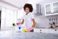 African Woman Cleaning Kitchen Counter