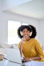 Happy African young woman student wearing headphones elearning at home. Royalty Free Stock Photo