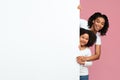 Happy Afro-American Mother And Daughter Peeking Out Of Blank White Board Royalty Free Stock Photo